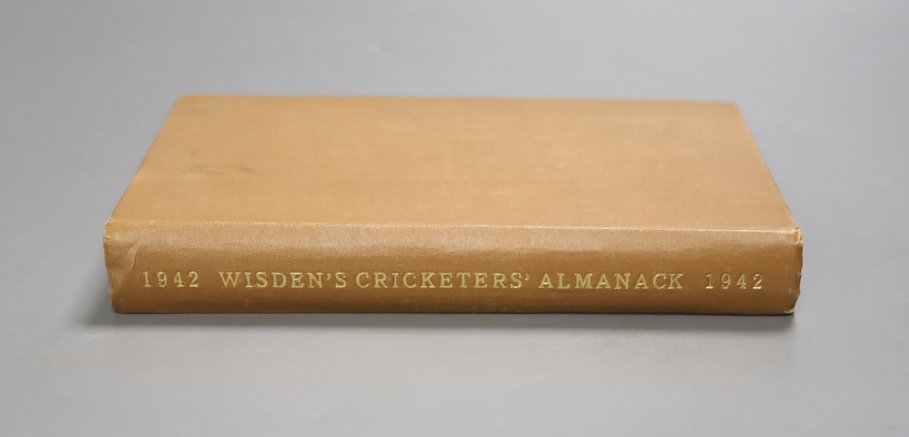 Wisden Cricketers' Almanack, 1942 - pictorial title vignette, photo plates, gilt lettered brown cloth preserving the original pictorial